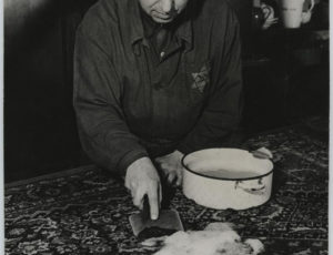 Carpet cleaning by an employee with the yellow badge (source: http://collections.jewishmuseum.cz)